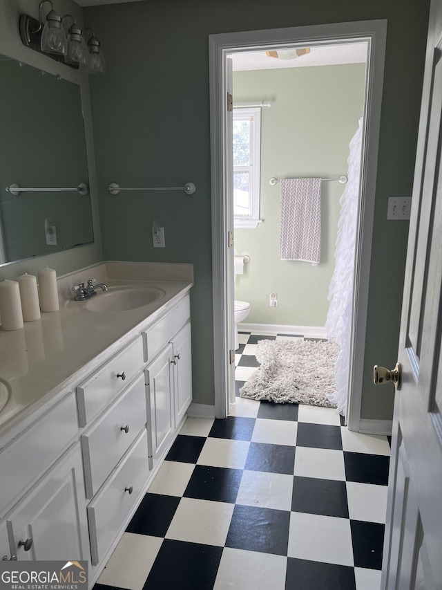 bathroom with toilet and vanity