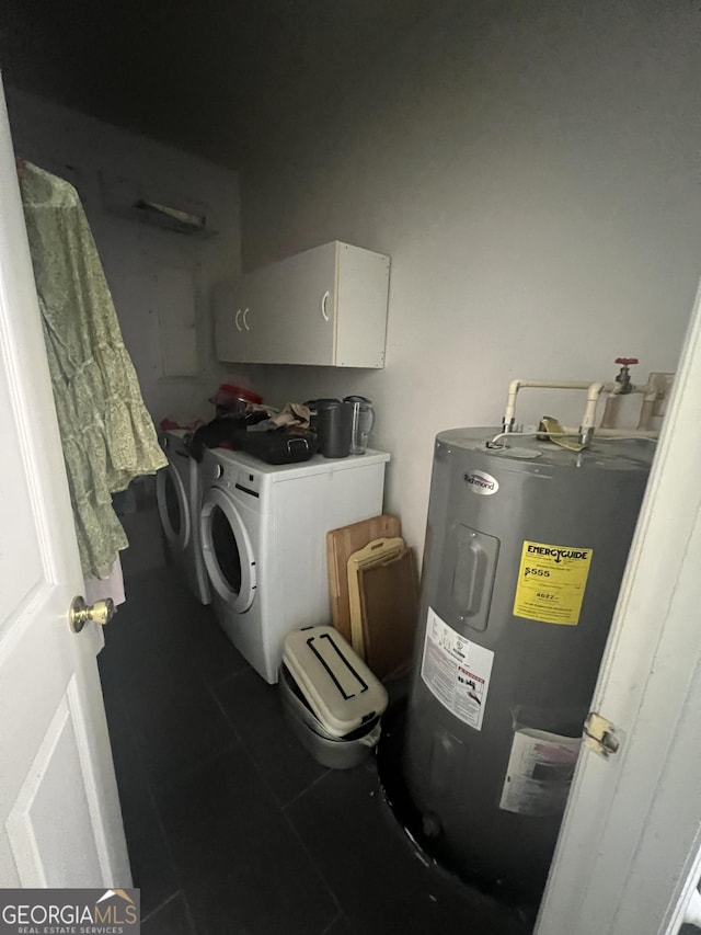 laundry room featuring cabinets, washer and clothes dryer, and water heater