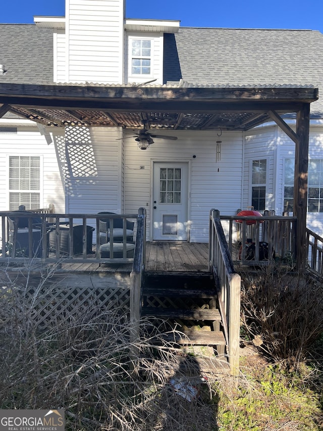 back of house with ceiling fan and a wooden deck