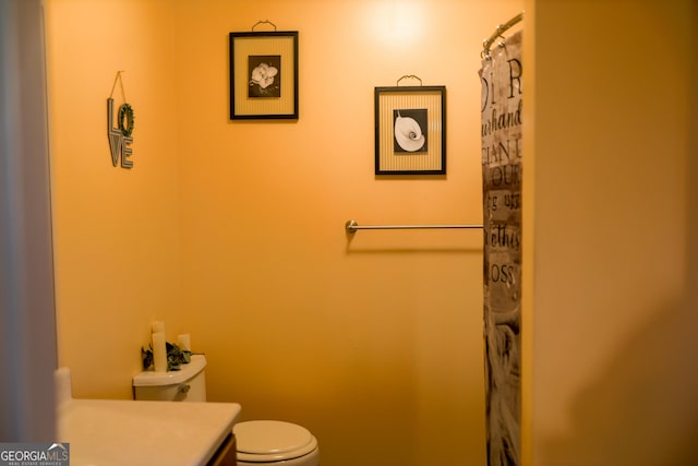 bathroom featuring toilet and vanity