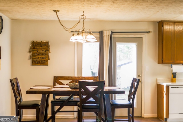 dining room with a textured ceiling and an inviting chandelier