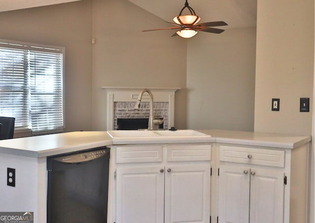 kitchen with ceiling fan, dishwasher, vaulted ceiling, white cabinets, and sink