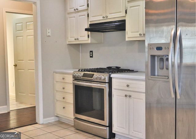 kitchen with light tile patterned floors, white cabinets, and appliances with stainless steel finishes