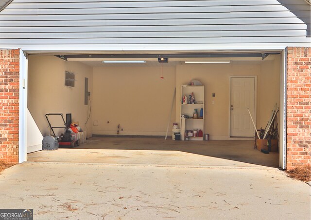 garage featuring electric panel and a garage door opener