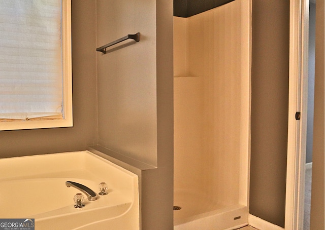 bathroom featuring separate shower and tub