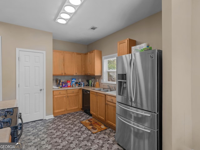 kitchen with light brown cabinetry, sink, tasteful backsplash, and black appliances