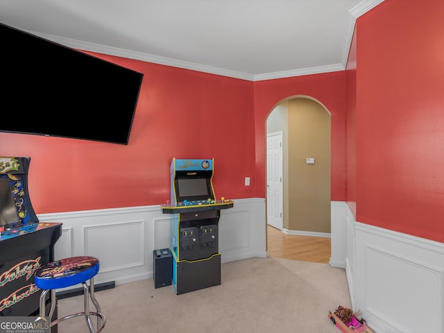 game room with light carpet and ornamental molding