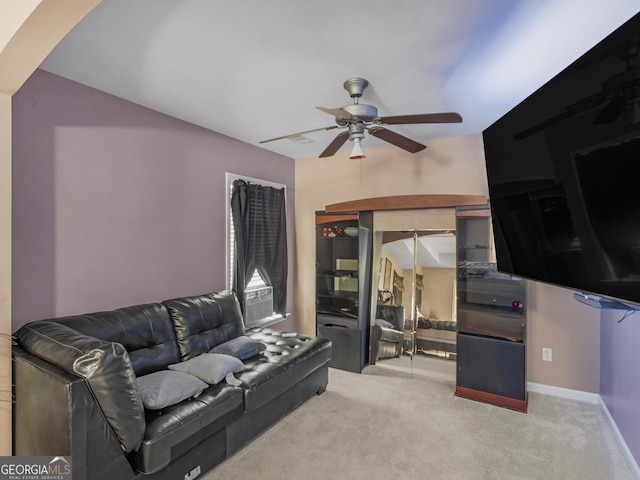 carpeted living room with ceiling fan