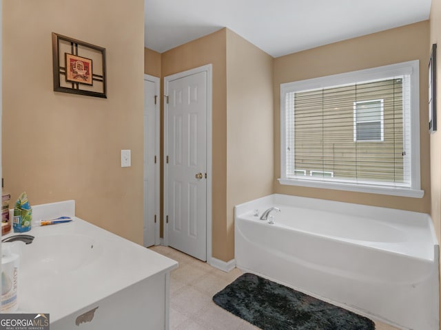 bathroom featuring a washtub and vanity