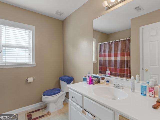 bathroom with toilet, tile patterned flooring, and vanity