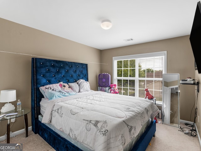 bedroom featuring light carpet