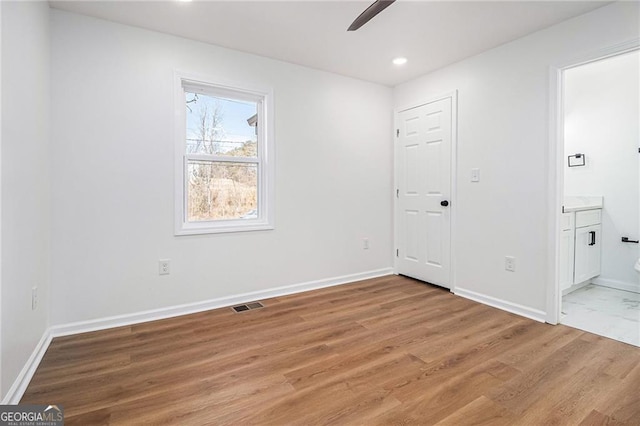 unfurnished room featuring hardwood / wood-style floors and ceiling fan