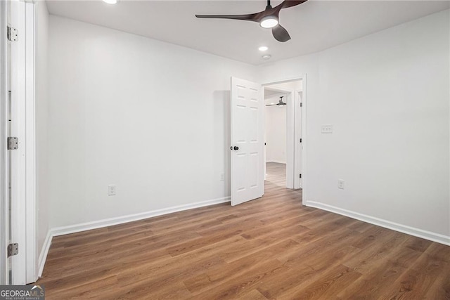 empty room featuring ceiling fan and dark hardwood / wood-style flooring