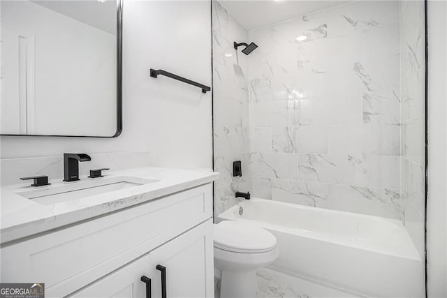 full bathroom with vanity, toilet, and tiled shower / bath