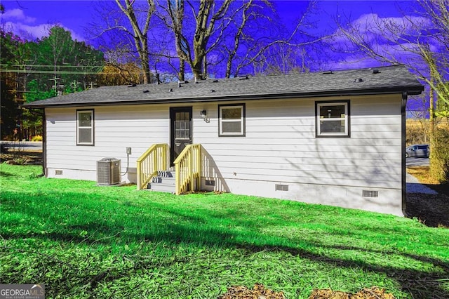 back of property featuring central AC and a lawn