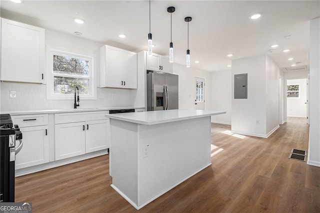 kitchen with sink, a center island, white cabinets, and appliances with stainless steel finishes