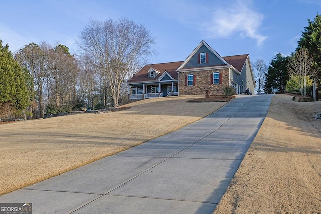 view of front of house with a front yard and a porch