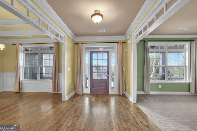 spare room featuring ornamental molding and carpet