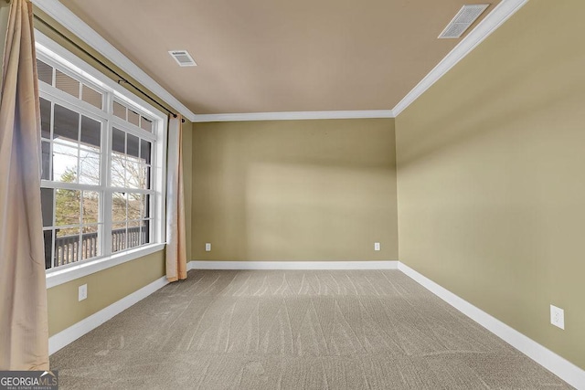 carpeted empty room featuring ornamental molding, visible vents, and baseboards