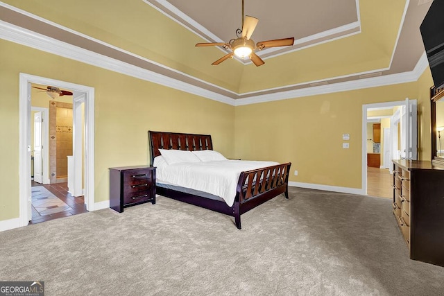 bedroom with carpet, baseboards, crown molding, and a tray ceiling