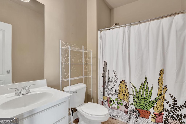 bathroom with curtained shower, vanity, and toilet