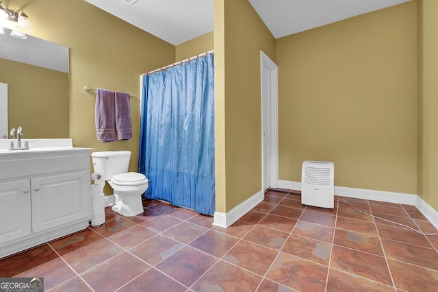 bathroom with toilet, tile patterned flooring, and baseboards