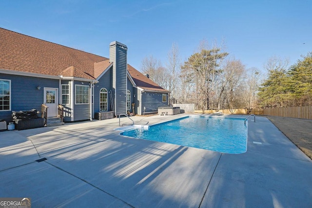 view of swimming pool with a fenced backyard, a fenced in pool, and a patio