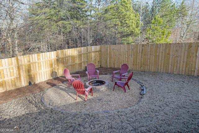 view of yard with an outdoor fire pit and a fenced backyard