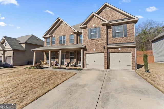 view of front of property featuring a front lawn, cooling unit, covered porch, and a garage