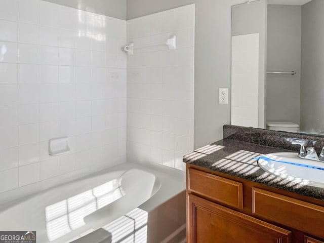 bathroom featuring toilet and vanity