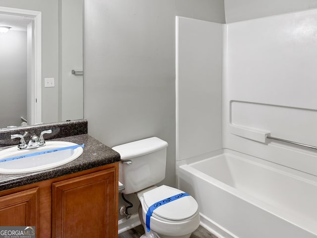 full bathroom featuring toilet, bathing tub / shower combination, and vanity