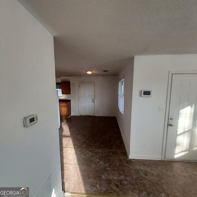 corridor with a textured ceiling