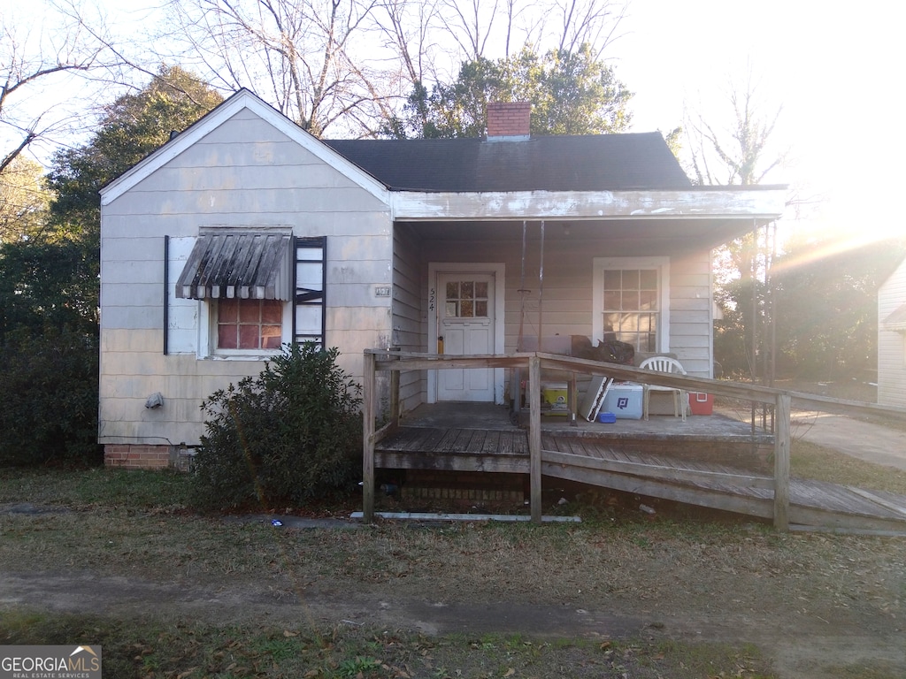 524 Ormond Ter, Macon, GA 31206 - view of front facade with a chimney, a deck, and crawl space