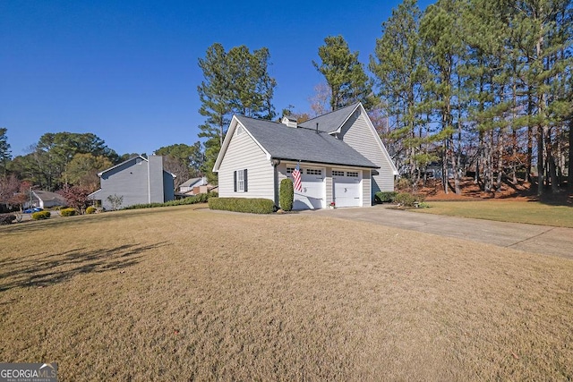 view of side of home with a garage and a lawn