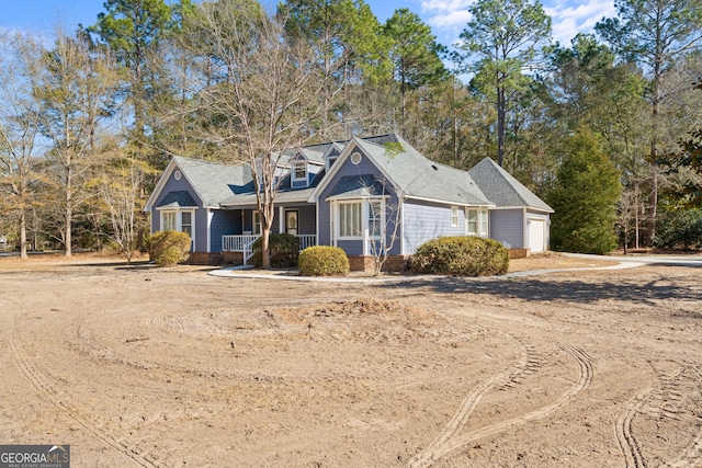 view of front of property featuring covered porch and a garage