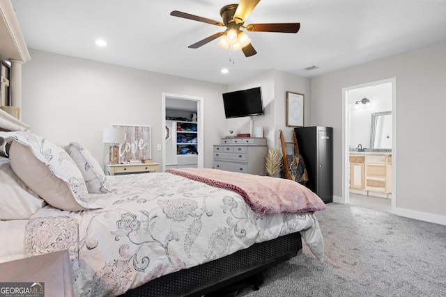 bedroom featuring ceiling fan, connected bathroom, and carpet floors