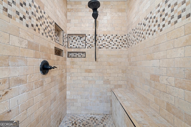 bathroom with tiled shower