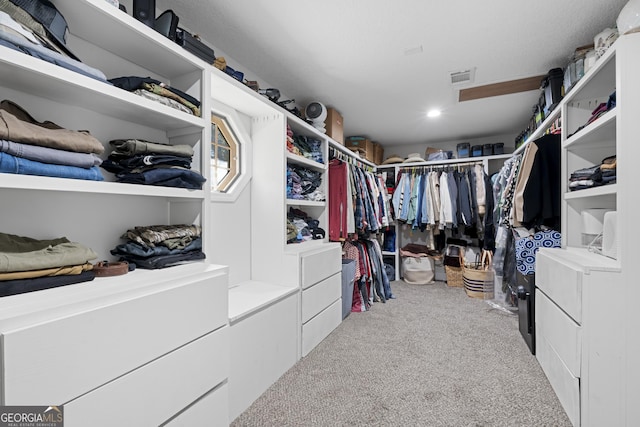 spacious closet featuring light carpet