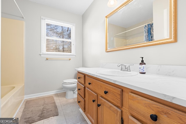 bathroom with toilet, vanity, and tile patterned floors