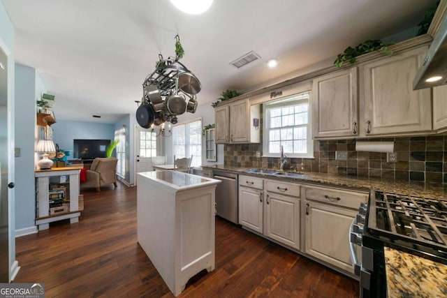 kitchen with sink, dark hardwood / wood-style floors, dishwasher, and range with gas stovetop