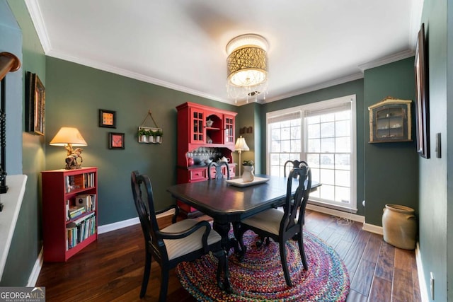 dining space with dark hardwood / wood-style floors and crown molding