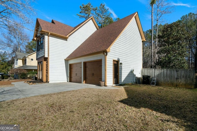 view of home's exterior with a garage and a yard