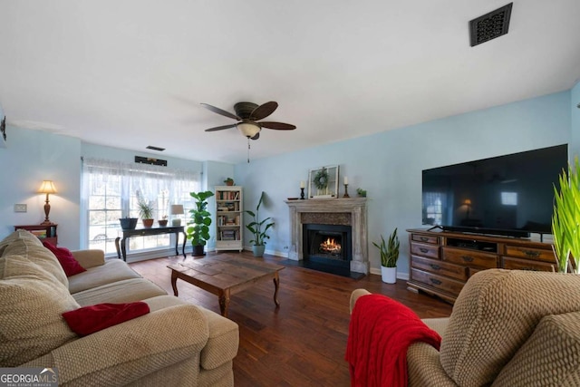 living room featuring ceiling fan and dark hardwood / wood-style flooring