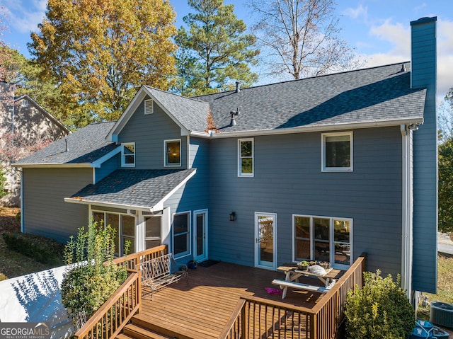 back of property featuring central air condition unit and a deck