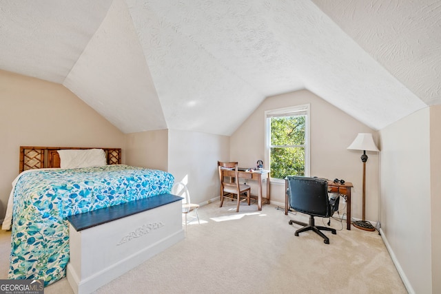 bedroom featuring vaulted ceiling, a textured ceiling, and carpet