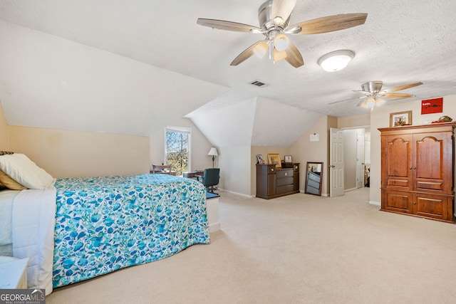 bedroom with lofted ceiling, ceiling fan, light carpet, and a textured ceiling