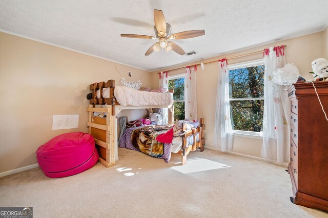 carpeted bedroom featuring a textured ceiling and ceiling fan