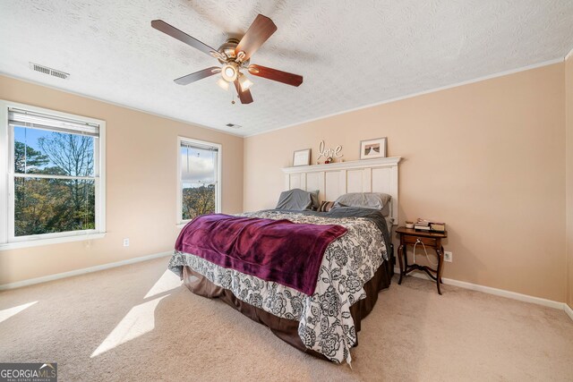 laundry area with cabinets, washer and dryer, and a textured ceiling