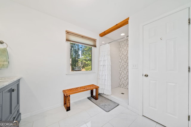 bathroom with walk in shower and vanity