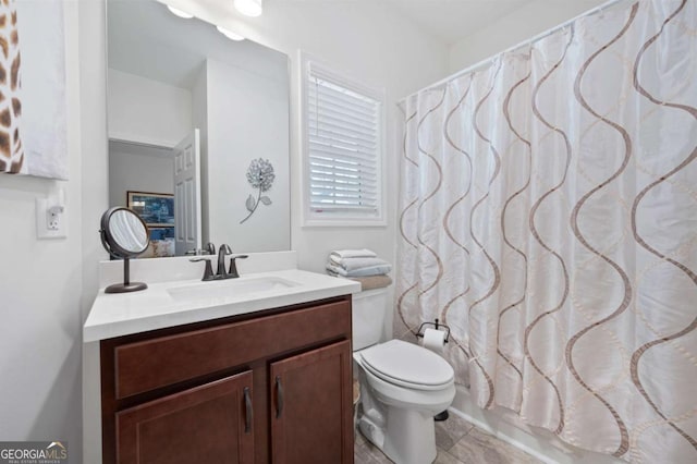 full bathroom featuring toilet, vanity, and shower / bath combo with shower curtain